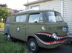 an old vw van with a shark's teeth painted on the front and side