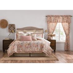 a bed with pink and beige comforters in a bedroom