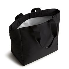 a black tote bag sitting on top of a white floor