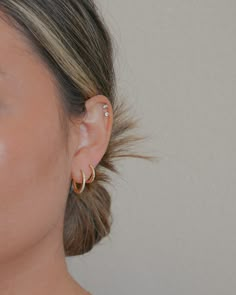 a close up of a person with ear piercings