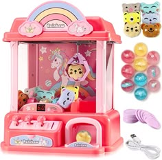 a pink toy machine with lots of toys around it