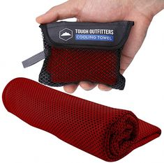 a hand holding an oven mitt and towel in it's pouch next to a heat mat