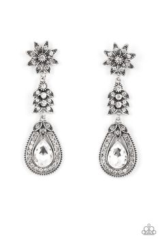 Dotted in dainty white rhinestones, a studded silver flower gives way to a leafy frame that is delicately suspended above a decorative white rhinestone dotted teardrop frame. An oversized teardrop gem seemingly floats inside the center of the lowermost frame, adding iridescent dazzle to the floral fairytale. Due to its prismatic palette, color may vary. Earring attaches to a standard post fitting. Fantasy Earrings, White Earring, Dainty Band, Floral Accessories, Paparazzi Accessories, White Rhinestone, Rhinestone Studs, White Earrings, Paparazzi Jewelry