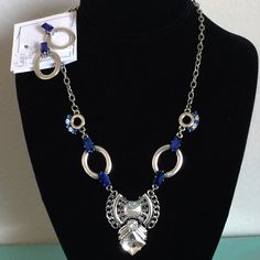 This New Women's Fashion Silver Necklace And Earring Set Is 18" Along With A 2" Drop And Claw Closure. The Necklace Contains Fashion Blue And Clear Crystals. The Earrings Are Fashion Silver With Blue And Clear Crystals. This Set Is Sold By A Vendor Called Howard's Sold By Gigi's Tre Chic Blue Metal Jewelry Sets, Nickel Free Blue Jewelry Sets, Blue Sterling Silver Costume Jewelry, Blue Costume Jewelry In Sterling Silver, Blue Nickel-free Costume Jewelry, Sapphire Metal Jewelry For Party, Sapphire Party Jewelry, Blue Costume Jewelry Sets, Nickel-free Sapphire Jewelry For Party