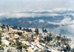 snow covered mountains and valleys are seen from the top of a hill in this aerial view