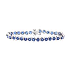 "Lab-created sapphire gemstones give this sterling silver tennis bracelet alluring appeal.BRACELET DETAILS Length: 7.25 in. Clasp: box Metal: rhodium-plated sterling silver STONE DETAILS Stone type: lab-created sapphire Total weight: 8 1/2 ct. Shape: round Setting: bezel  Size: 7.25"". Color: Blue. Gender: female. Age Group: adult." Sapphire Tennis Bracelet With 17 Jewels, Classic Sapphire Tennis Bracelet With Round Shape, Blue Round Tennis Bracelet With Prong Setting, Classic Blue Diamond Bracelet In Sterling Silver, Blue Tennis Bracelet With Prong Setting, Sapphire Brilliant Cut Tennis Bracelet, Classic Sapphire Gemstone Tennis Bracelet, Classic Blue Sterling Silver Diamond Bracelet, Classic Blue Sterling Silver Tennis Bracelet