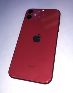 an apple iphone 11 is shown in this close up photo taken from the back, on a white surface