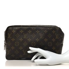 This is an authentic LOUIS VUITTON Monogram Trousse Toilette 28. This travel pouch is crafted of signature Louis Vuitton monogram on toile canvas. This pouch features a beige interior with a patch pocket and elastic holders for cosmetic bottles. Beige Interior, Cosmetic Bottles, Travel Pouch, Authentic Louis Vuitton, Louis Vuitton Monogram, Patch Pocket, Louis Vuitton, Pouch, Monogram