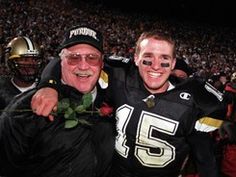 two football players are posing for a photo with their arms around each other at a game