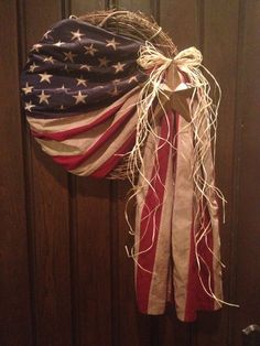 an american flag wreath hanging on a door