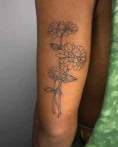 a woman with a flower tattoo on her arm