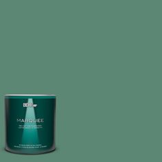 a can of behr marquee paint on a green background