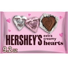 hershey's heart shaped candy bars are displayed on a pink background