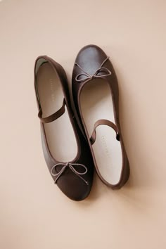 Soft ballet flat in chocolate brown Italian glove calf leather with an elastic bridge strap and bow detail. Features a padded footbed with gold stamped logo and an almond toe. Ballet Flats For Women, Brown Low Heel Ballet Flats For Formal Occasions, Formal Brown Ballet Flats With Flat Heel, Elegant Brown Leather Ballet Flats, Brown Ballet Flats With Bow, Elegant Brown Ballet Flats With Removable Insole, Elegant Brown Ballet Flats With Round Toe, Elegant Brown Round Toe Ballet Flats, Chic Brown Ballet Flats With Round Toe