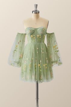 Make a statement in this vibrant, verdant dress! A tulle A-line with floral embroidery, corset bodice, and lacing up the back - it's all topped off with puff-sleeved perfection just above the knee! Homecoming Dresses Cottagecore, Floral Tulle Dress Short, Hoco Dresses Green Flowy, Fairy Core Dress Short, Homecoming Dress Inspiration, Spring A-line Corset Dress For Prom, Spring A-line Corset Dress With Corset Back, Spring Green Dresses With Corset Back, Fitted Dress With Sweetheart Neckline And Floral Applique