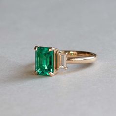 For Sale on 1stDibs - Emerald adorned with baguette diamonds Stone: Lab Grown Emerald Cut: Emerald/Step Three stone ring Stone Size: 8 x6 mm Baguette Diamonds: Two 4.5 x 2 mm Timeless Moissanite Baguette Cut Emerald Ring, Baguette Cut Three Stone Emerald Diamond Ring, Classic Emerald Ring With Baguette Diamonds In 14k Gold, Classic 14k Gold Emerald Ring With Baguette Diamonds, Art Deco Emerald Ring With Baguette-cut Diamond, Gia Certified Baguette Cut Emerald Ring In 14k Gold, Art Deco Emerald Ring With Baguette Diamond, Classic Emerald Ring With Baguette Diamonds, Timeless Emerald Ring With Baguette Diamonds