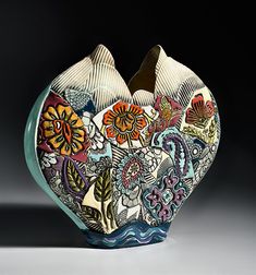 an artistic vase with many different designs on it