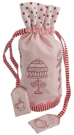 a pink bag with red and white polka dots on it, next to a cupcake