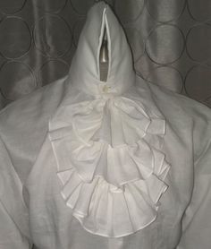 Here we have combined an 18th Century Collar and Neck Ruffles with a modern fit body in an excellent 100% linen. Made with a modern fit body for comfort, with real mother of pearl shell buttons Extra high collar is sculpted in back, for easy wear Shoulder yoke has a pleat at center back Cuffs can be folded back for French cuff effect, or left down for the Poet's sleeve look. Order by Neck, chest and sleeve measurements Elegant Linen Tops With Buttons, Elegant Formal Linen Tops, Elegant Fitted Linen Blouse, White Linen Top For Formal Occasions, Elegant White Shirt With Ruffled Collar, Formal Fitted Linen Blouse, White Linen Formal Shirt, Formal White Linen Shirt, Elegant White Linen Top