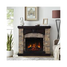 a living room with a fire place in the center and pictures on the wall above it