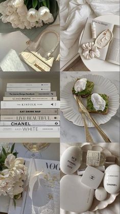 there are many white flowers and books on the table