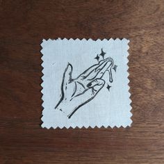 a piece of cloth with a drawing of a hand holding a star on top of it