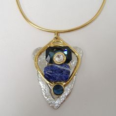 Large Chunky Blue & Crystal Pendant Necklace By J. Jansen. Unique Necklace In Clear Crystal & Shades Of Blue Colored Semi-Precious Stones. Plated In 24 Kt Gold & A Non-Tarnish Silver Finish. Adjustable Length From Approx. 14" To 16". New With Tag. 100 407 263 Luxury Blue Jeweled Necklaces, Modern Blue Pendant Jewelry, Elegant Blue Crystal Necklace With Gemstone Accents, Modern Blue Necklaces For Parties, Blue Costume Jewelry With Stones, Blue Crystal Costume Jewelry Necklace, Modern Blue Necklace For Party, Blue Crystal Necklace Costume Jewelry, Unique Blue Necklaces With Gemstone Accents