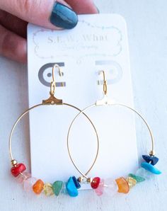 Rainbow gemstone hoop earrings. This combination of gemstones displays the beautiful colors of the rainbow. Stays secure with our flower rubber backings. Each earring is uniquely made with love and durable for everyday wear.Stones: Red Coral Bamboo, Rose Quartz, Quartz, Citrine, Ametrine, Aquamarine, TurquoiseLength: Approx. 2inMaterials: 40mm nickel-free plated brass hoops, 925 sterling silver/925 14k gold plated sterling silver earringwires, 3mm gold/silver zinc alloy (lead-free) beads 10% OF