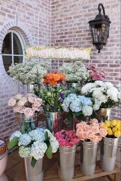 a bunch of flowers that are in buckets