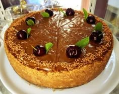 a cake with chocolate frosting and cherries on top