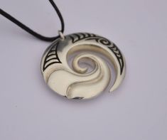 Hand crafted New Zealand Maori koru in Solid .925 sterling silver. Finished by hand to a high polish with traditional Maori engraved detail and hung on a black adjustable cord. The Maori koru design is a treasured symbol in New Zealand that represents nature . It brings personal growth and renewal of the spirit (Wairua) with inspiration for new ideas & adventures. We have added a sculptural wave design to bring energy & vitality and connections with the ocean. Unique New Zealand designs