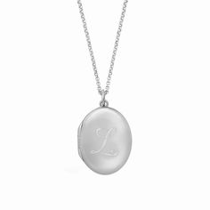 Our new, timeless oval locket necklace is an elegant way for you to carry your loved ones close to your heart. Hold pictures of your loved ones or a memento that is special to you. Engrave an initial on the front and up to 3 names/phrase on the back. available in gold vermeil and sterling silver lockets are engraved using diamond drag technology opens with space inside for 2 pictures, which fit easily inside the locket. See our guide for adding photos to your locket hangs on adjustable length ro Classic Monogram White Gold Necklace, Personalized Oval Heirloom Necklace, Heirloom Oval Personalized Necklaces, Elegant Oval Link Locket Necklace, Classic Oval Link Personalized Necklace, Classic Oval Link Locket Jewelry, Elegant Monogram Medallion Necklace, White Gold Oval Link Locket Necklace, Oval Link Necklaces With Polished Finish For Weddings