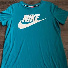 Teal Nike Tshirt Never Worn Unisex Basic Green Tops With Logo Print, Green Basic Top With Logo Print, Nike Basic Graphic Print Top, Nike Basic Top With Graphic Print, Casual Nike Short Sleeve Tops, Basic Blue Sports T-shirt, Nike Blue T-shirt For Spring, Nike Green T-shirt With Graphic Print, Basic Blue T-shirt For Sports