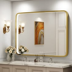 a bathroom with two sinks and a large gold framed mirror on the wall above it