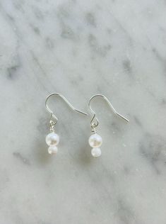 Dainty pearl dangle earrings perfect for any occasion as they are lightweight and versatile. Chic Silver Dangle Pearl Earrings, Everyday Silver Earrings With Pearl Chain, Chic Sterling Silver Pearl Earrings For Gifts, Elegant Adjustable Beaded Pearl Earrings, Everyday Adjustable Drop Pearl Earrings, Adjustable Pearl Drop Earrings, Pearl White Dangle Earrings, Feminine Style, Everyday Pearl White Dangle Jewelry, Pearl White Dangle Jewelry For Everyday