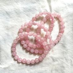 Elevate your style and well-being with our Pink Rose Quartz Bracelet. This exquisite bracelet features genuine rose quartz beads, renowned for their ability to attract love, promote emotional healing, and create a sense of calm. The soft pink hues of the rose quartz beads add a touch of elegance to any outfit, making it suitable for both everyday wear and special occasions. Our skilled artisans handcraft each bracelet with attention to detail, ensuring that you receive a unique piece that carrie Pink Rose Quartz Bracelets For Meditation, Pink Rose Quartz Bracelet For Meditation, Spiritual Rose Quartz Crystal Bracelet, Elegant Rose Quartz Crystal Bracelet For Meditation, Rose Quartz Beaded Bracelets For Meditation, Spiritual Rose Quartz Pink Bracelets, Rose Quartz Round Crystal Bracelet For Meditation, Rose Quartz Crystal Bracelet For Meditation, Round Rose Quartz Crystal Bracelet For Relaxation