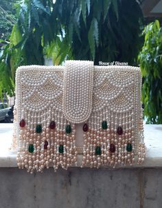 This is a beautiful handcrafted clutch bag made with love.It has intricate handwork which showcases the Indian craftsmanship by our local artisans. It comes with a pearl handle. Details  - Single side handwork  - Fabric lining on the inside to keep your belongings safe  - Magnetic lock closure  - Detachable handle  This clutch can be worn as a crossbody bag or a shoulder bag with the sling chain or can simply be carried in hand.It is spacious enough to carry mobile phones, lipsticks, Keys and ot Polti Bag, Pochette Diy, Clutch Tutorial, Hand Beaded Bag, Diy Clutch, Fancy Hands, Handmade Clutch, Bridal Accessory, Magnetic Lock