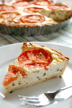 a slice of pizza on a plate with a fork next to it and another pie in the background