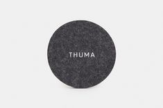 a round black object with the word'thum'written in white on it