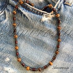 This beautiful tiger eye beads necklace is perfect for surf lovers who want to add a touch of natural beauty to their style. The warm and earthy tones of the tiger eye beads evoke a sense of calm and grounding, making it an ideal accessory for those who enjoy spending time by the ocean. Handcrafted with care and attention to detail, this necklace is a unique piece that will complement any beach-inspired outfit. Whether you're hitting the waves or simply soaking up the sun, this necklace is sure Everyday Spiritual Brown Necklace, Casual Brown Beaded Necklaces, Casual Brown Necklaces For The Beach, Casual Brown Necklace For Beach, Brown Handmade Necklaces For Everyday Wear, Everyday Handmade Brown Necklaces, Brown Gemstone Beads Necklace For Beach, Everyday Brown Wooden Beaded Necklaces, Handmade Brown Necklace For Everyday Wear