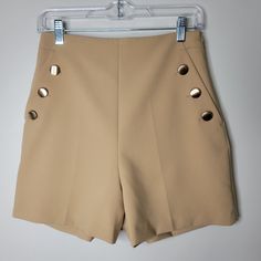 Tan High Waisted Sailor Girl Style Dressy Shorts With Gold Hardware. Zips Up On Left Side. Waist 13" Length 16" Inseam 4" Front Rise 13.5" Beige Fitted Short Skort, Fitted Beige Short Skort, Fitted Beige High-waisted Shorts, Beige High-waisted Shorts With Button Closure, Fitted High-waisted Shorts With Button Closure, Beige Button Closure Shorts For Summer, Beige Button Closure Summer Shorts, Zara Mini Bottoms For Summer, Fitted Beige Zara Shorts