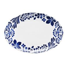 a blue and white plate with flowers on the rim, isolated against a white background