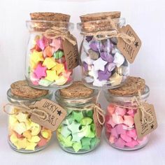 there are many small jars with different colored confetti in them