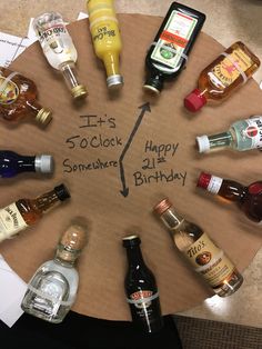 there is a birthday cake with liquor bottles around it and the words it's 5 oclock somewhere happy 21st birthday