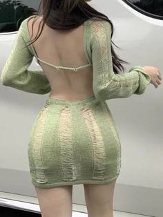 the back of a woman's body in a green dress