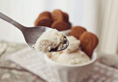 a spoon full of ice cream with cookies in the background