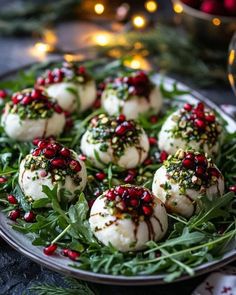 christmas desserts on a plate with greens and pomegranate