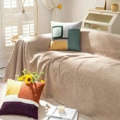 a living room filled with furniture and pillows