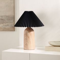 a table lamp sitting on top of a white dresser