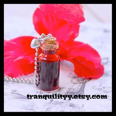 Welcome to Tranquilityy a magical embrace into your world I have for you an inviting vial of vampire blood on a silver link or 30" ball chain you will love to wear around your neck.  Your necklace is made from a mini 2ml glass vial bottle with realistic theatrical blood, I love this I even have one for myself. Your necklace will come in a drawstring bag, take care and god bless.  I miss the shine Of your ruby-red eyes The leathery feel of your face Your breath on my neck And the points of your teeth As you come unto me for a taste. Blood Necklace, Necklace Vampire, Magic Potions, Vampire Blood, Small Thank You Gift, Winter Necklace, Holiday Necklace, Moon Phases Necklace, Christmas Necklace